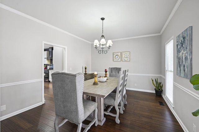 dining area featuring visible vents, crown molding, baseboards, an inviting chandelier, and wood-type flooring