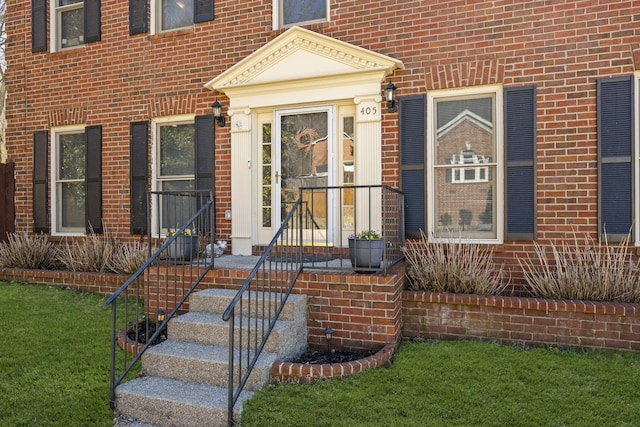 doorway to property with brick siding