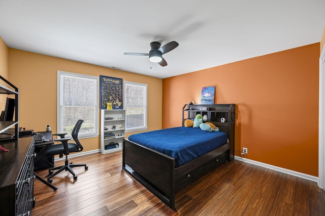 bedroom featuring ceiling fan, baseboards, and wood finished floors