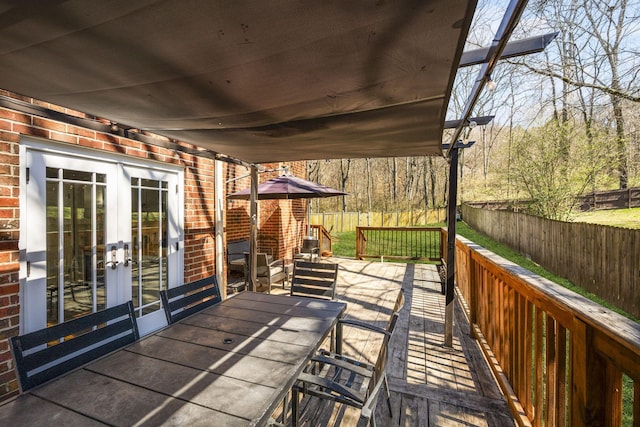 wooden terrace with french doors, fence private yard, and outdoor dining area