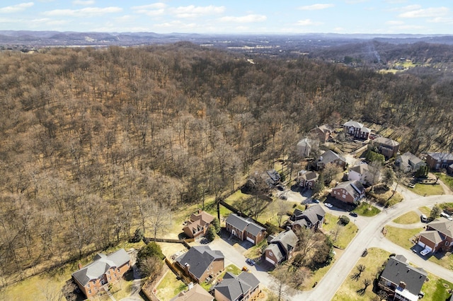 drone / aerial view with a residential view and a view of trees