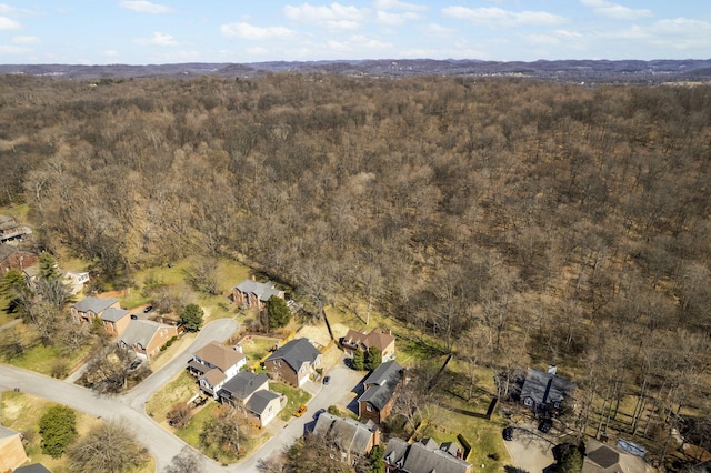 aerial view featuring a forest view and a residential view