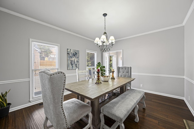 dining space featuring a chandelier, baseboards, a wealth of natural light, and wood finished floors