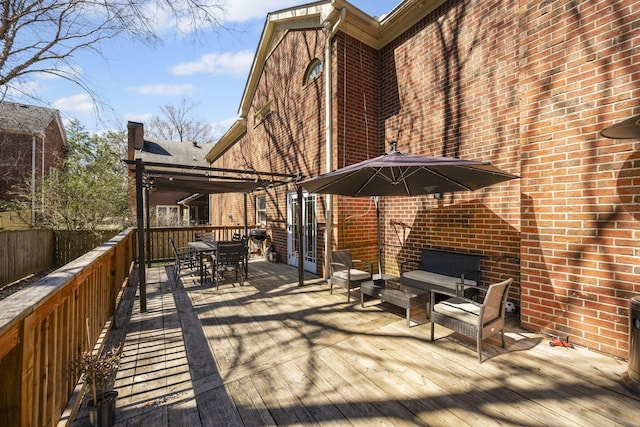 wooden deck featuring outdoor dining area