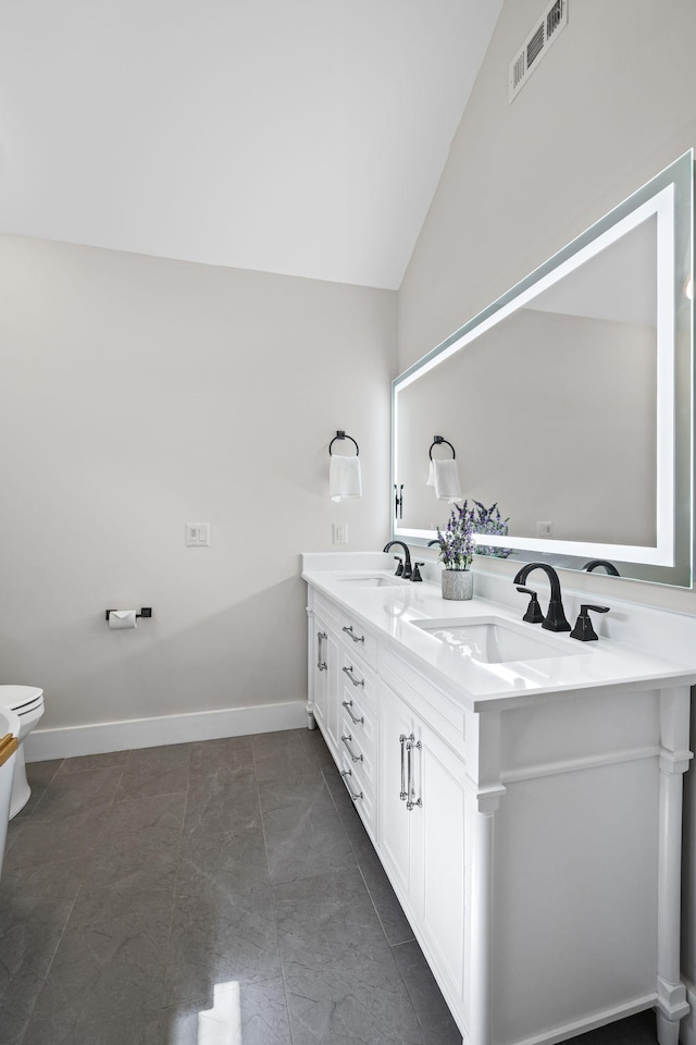 full bathroom featuring lofted ceiling, toilet, visible vents, and a sink