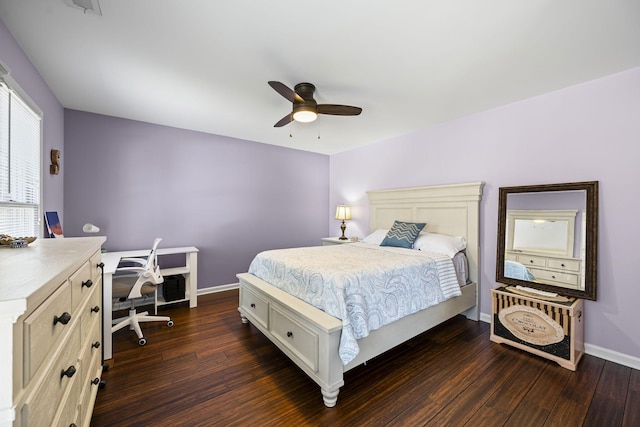 bedroom with dark wood-type flooring, a ceiling fan, and baseboards