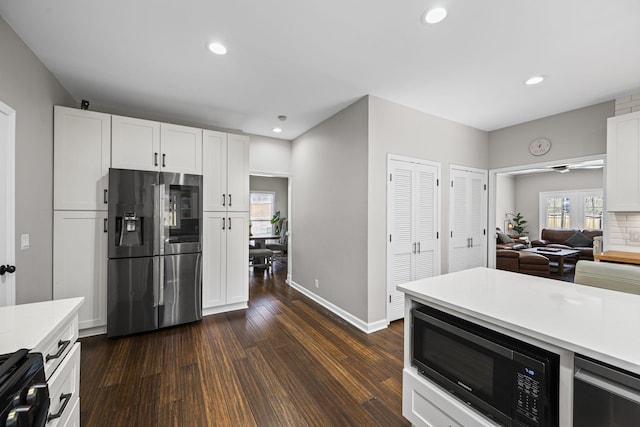 kitchen with built in microwave, light countertops, recessed lighting, dark wood-style floors, and stainless steel fridge