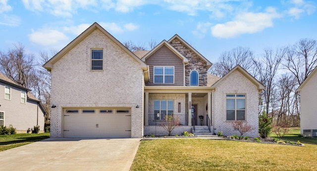 view of front facade with brick siding, concrete driveway, a front yard, covered porch, and an attached garage