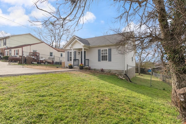 bungalow-style home featuring a front lawn, fence, and roof with shingles