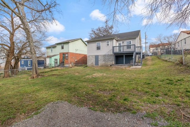 back of house featuring a deck, a lawn, stairs, and a fenced backyard