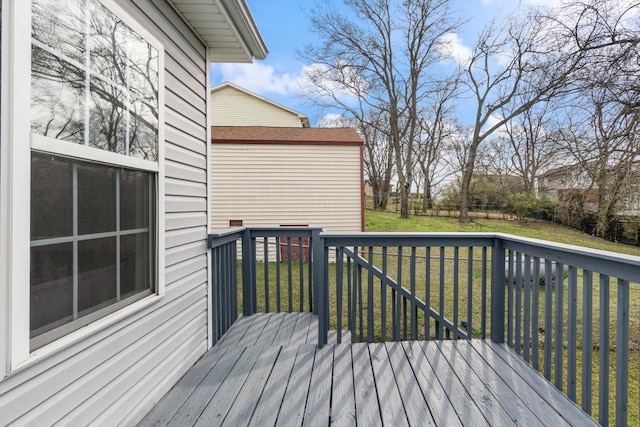 deck with a lawn and fence