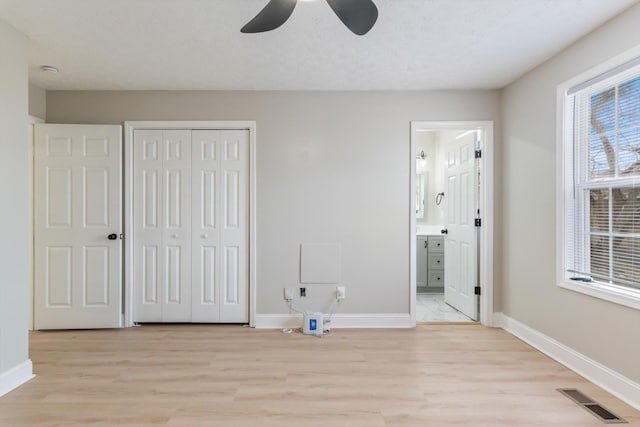 unfurnished bedroom with visible vents, baseboards, and light wood-style floors