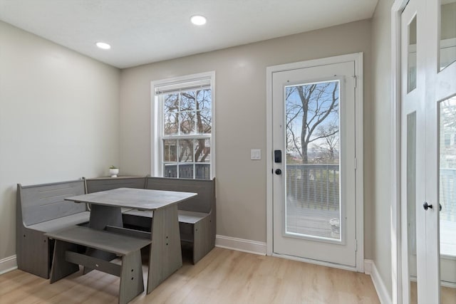 dining area with light wood-style flooring, recessed lighting, and baseboards