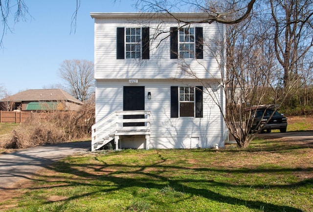 colonial-style house with a front yard