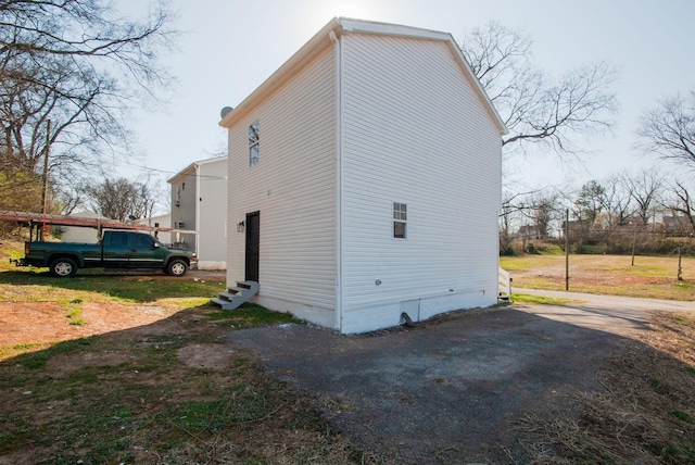 view of side of property with entry steps and crawl space