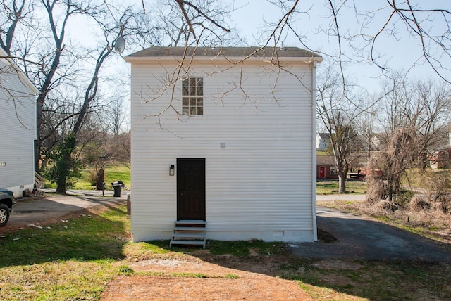 rear view of property featuring crawl space and entry steps