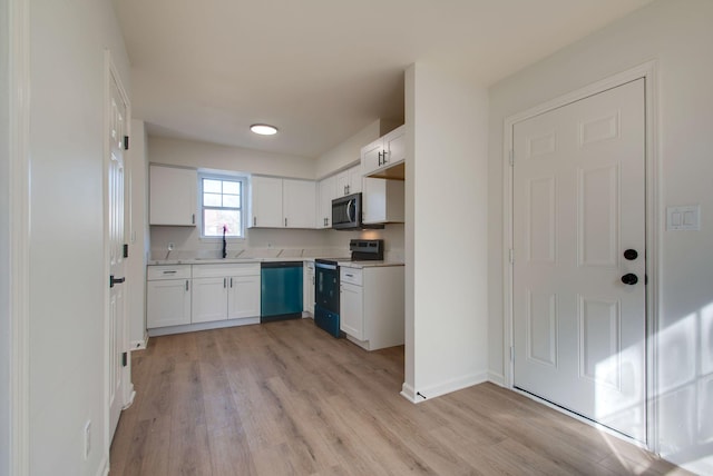 kitchen featuring range with electric cooktop, stainless steel microwave, white cabinets, light countertops, and dishwasher