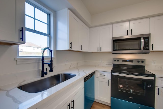 kitchen featuring range with electric cooktop, a sink, stainless steel microwave, white cabinets, and dishwasher