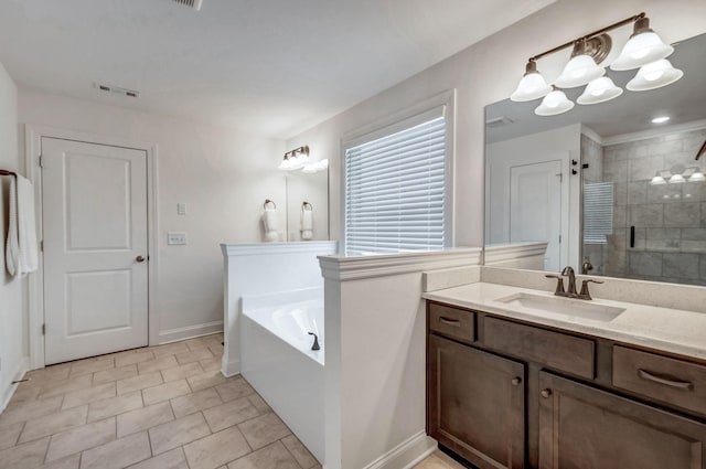 bathroom with vanity, visible vents, a shower stall, a garden tub, and a chandelier