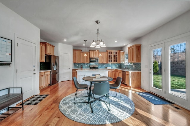 dining space with recessed lighting, visible vents, a chandelier, and light wood finished floors