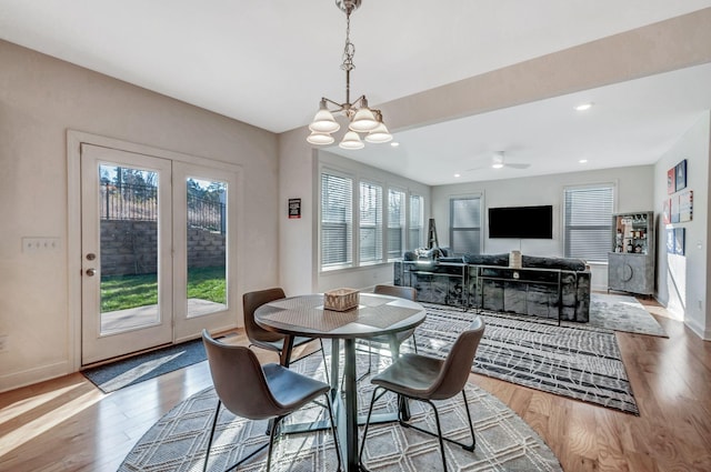 dining room with recessed lighting, baseboards, an inviting chandelier, and wood finished floors