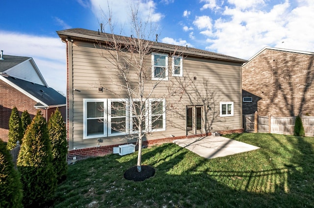 rear view of property with a yard, a patio area, and fence