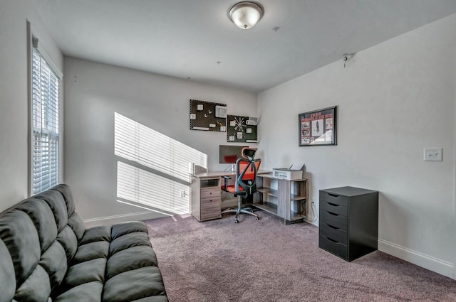 carpeted office space featuring baseboards