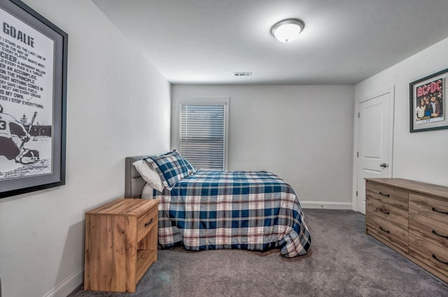 carpeted bedroom featuring visible vents and baseboards