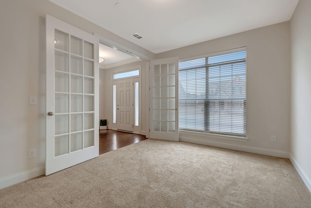 entryway featuring visible vents, baseboards, carpet flooring, and french doors