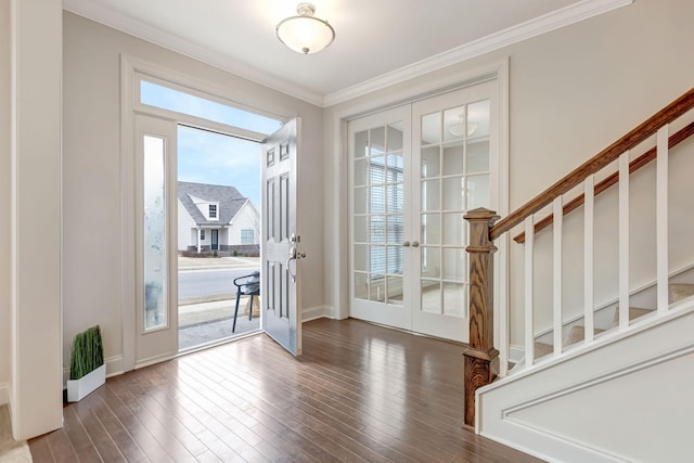 interior space with french doors, crown molding, baseboards, and hardwood / wood-style flooring