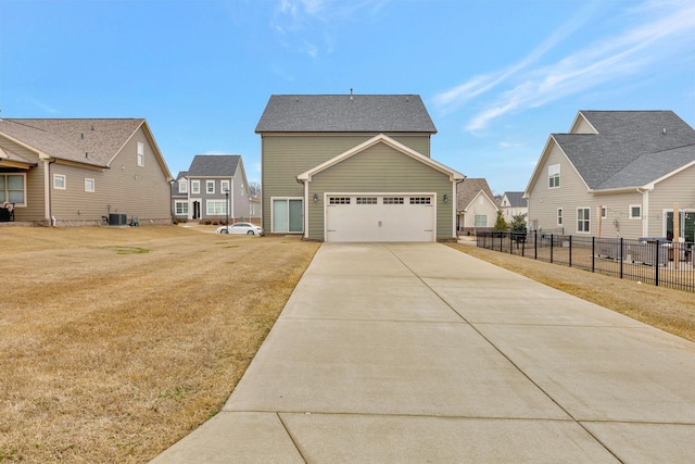 view of home's exterior with a lawn, driveway, fence, cooling unit, and an attached garage