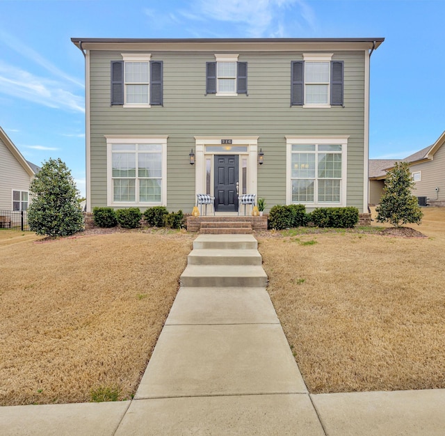 colonial-style house with a front lawn