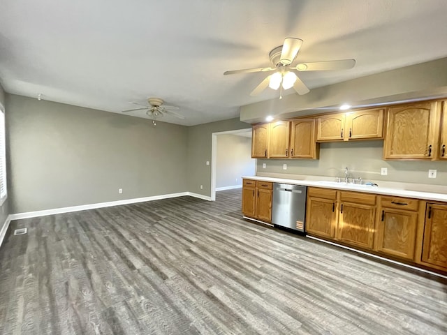 kitchen featuring baseboards, dark wood finished floors, a sink, ceiling fan, and dishwasher