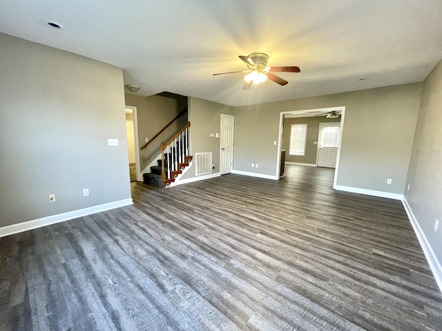 spare room featuring dark wood-style floors, visible vents, baseboards, and a ceiling fan