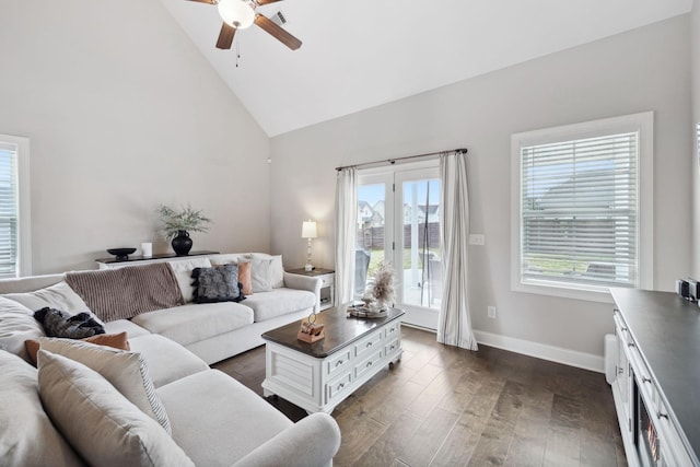 living area with visible vents, dark wood-type flooring, baseboards, ceiling fan, and high vaulted ceiling