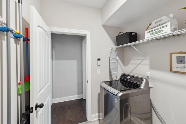 laundry area with laundry area, washer / clothes dryer, baseboards, and wood finished floors