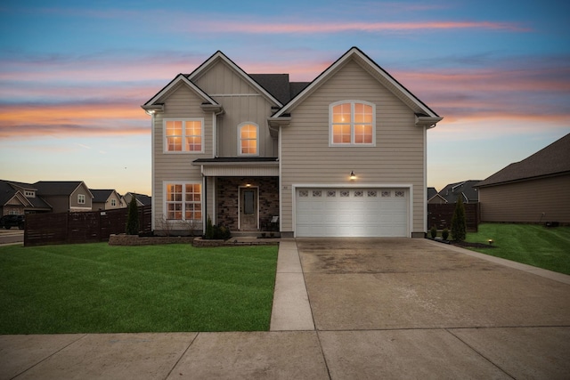 traditional home featuring fence, driveway, an attached garage, a lawn, and board and batten siding