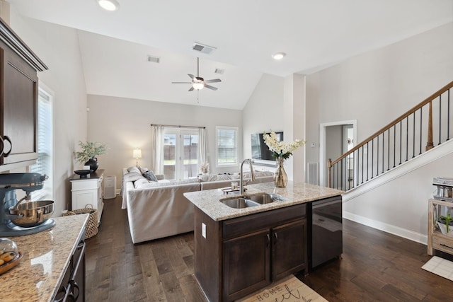 kitchen featuring visible vents, dark wood-style flooring, a sink, dark brown cabinets, and dishwasher