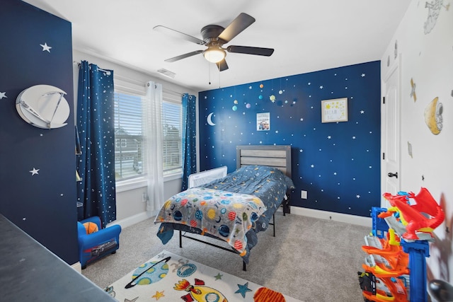 carpeted bedroom with wallpapered walls, visible vents, baseboards, and ceiling fan