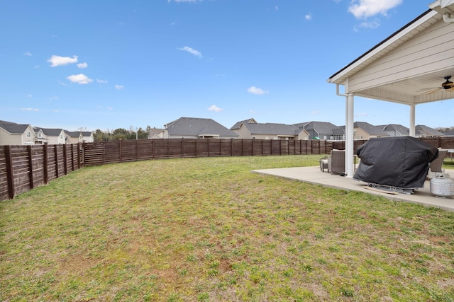 view of yard featuring ceiling fan, a residential view, a fenced backyard, and a patio area