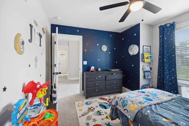 carpeted bedroom featuring baseboards and ceiling fan