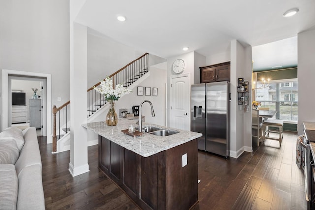 kitchen with a sink, dark brown cabinetry, dark wood-style floors, and stainless steel refrigerator with ice dispenser