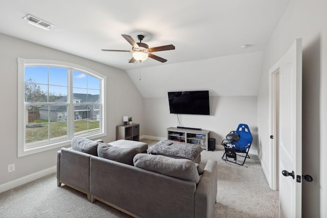 carpeted living room featuring lofted ceiling, a ceiling fan, visible vents, and baseboards