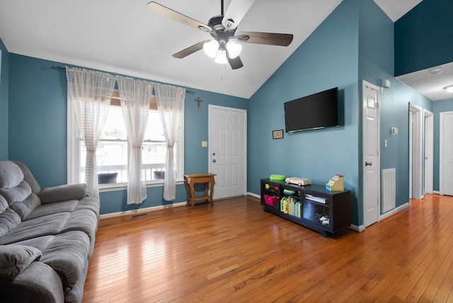 living room featuring baseboards, visible vents, wood-type flooring, and ceiling fan