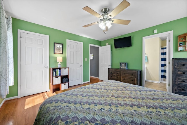 bedroom with a ceiling fan, baseboards, and wood finished floors