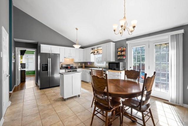 dining area featuring a wealth of natural light, visible vents, a chandelier, and light tile patterned flooring