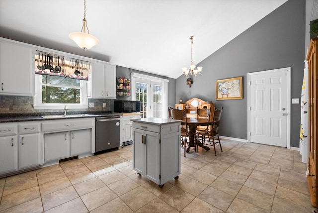 kitchen with a kitchen island, an inviting chandelier, a sink, black microwave, and dishwasher