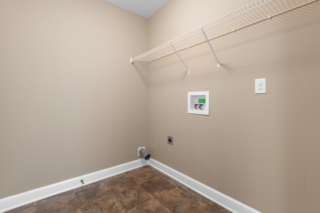 laundry area with hookup for a washing machine, baseboards, laundry area, electric dryer hookup, and stone finish flooring