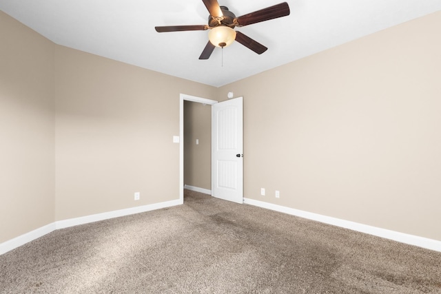 empty room with a ceiling fan, baseboards, and carpet floors