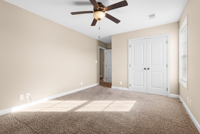 unfurnished bedroom featuring a closet, visible vents, carpet flooring, and baseboards